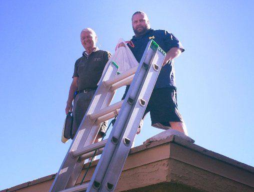 John and Scott on the roof doing a dryer vent cleaning