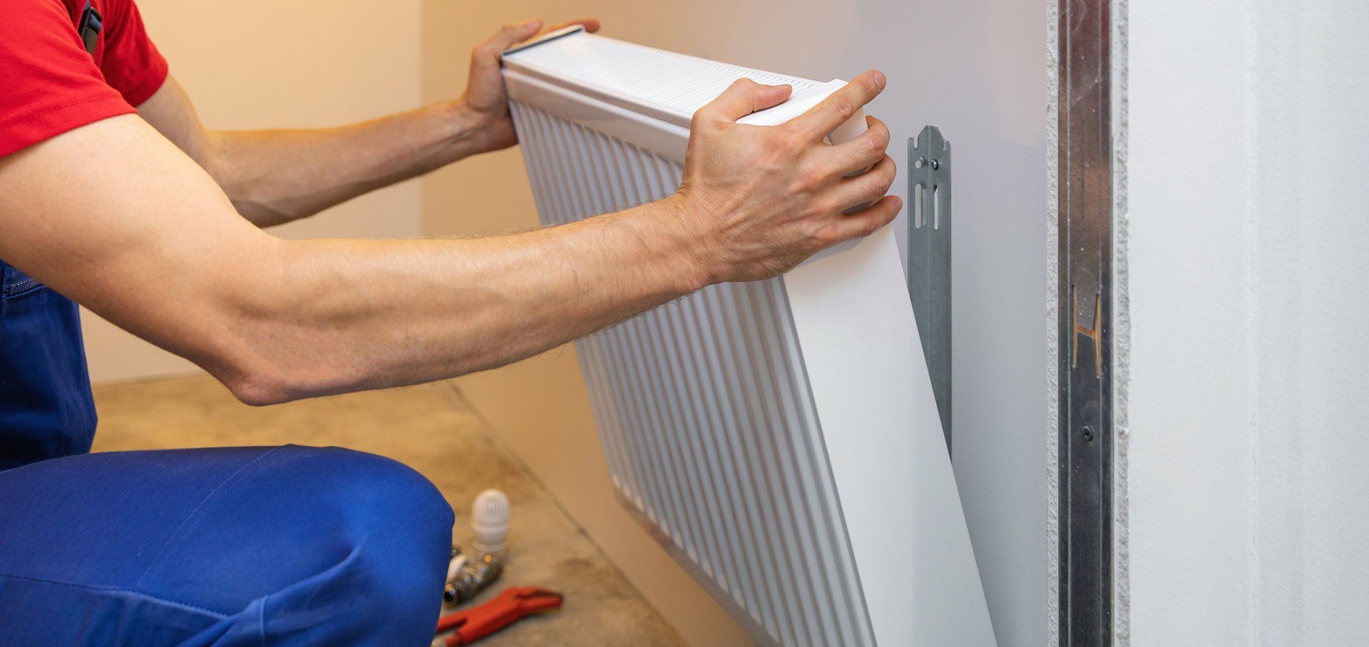 Man installing room heater on the wall