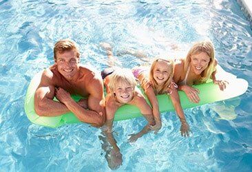 Family having fun in the Pool with a Floater — Pool Service in Kansas City, MO