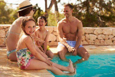 Family Sitting by Pool — Pool Service in Kansas City, MO
