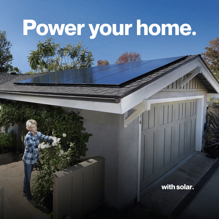 Solar panels on a red tile roof with a blue sky background.