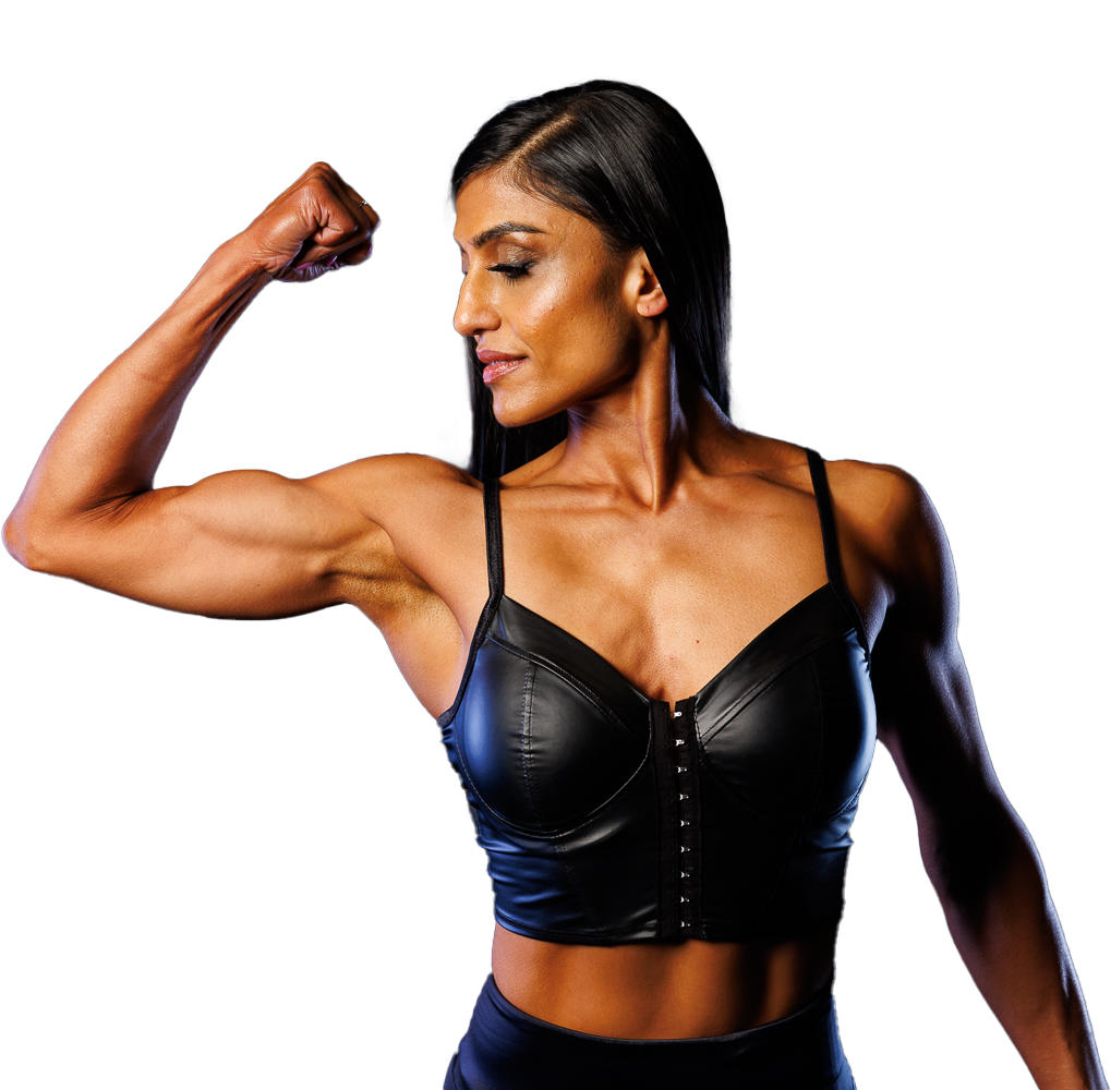 A woman in a black bra is flexing her muscles
