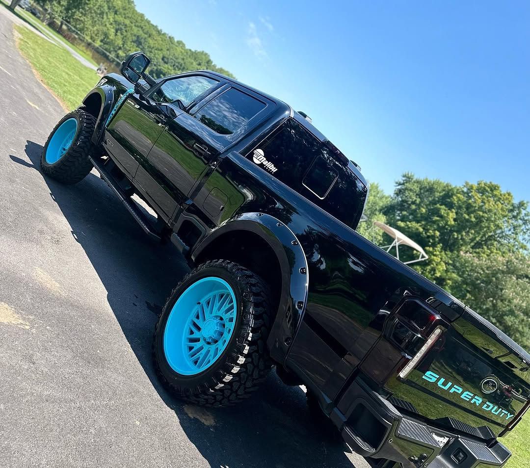 A black truck with blue wheels detailed by That's Clean in Frederick MD