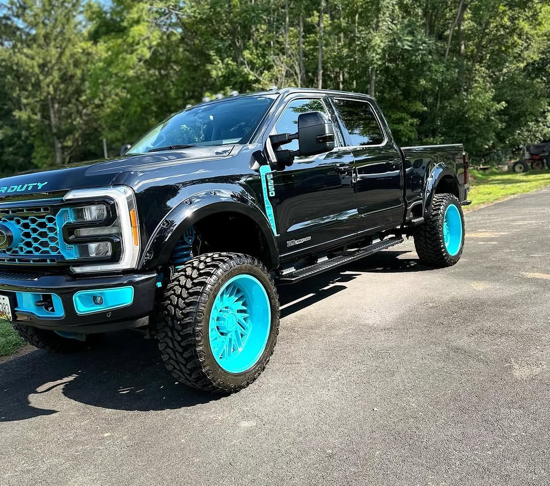 A black truck with blue wheels detailed by That's Clean in Frederick MD