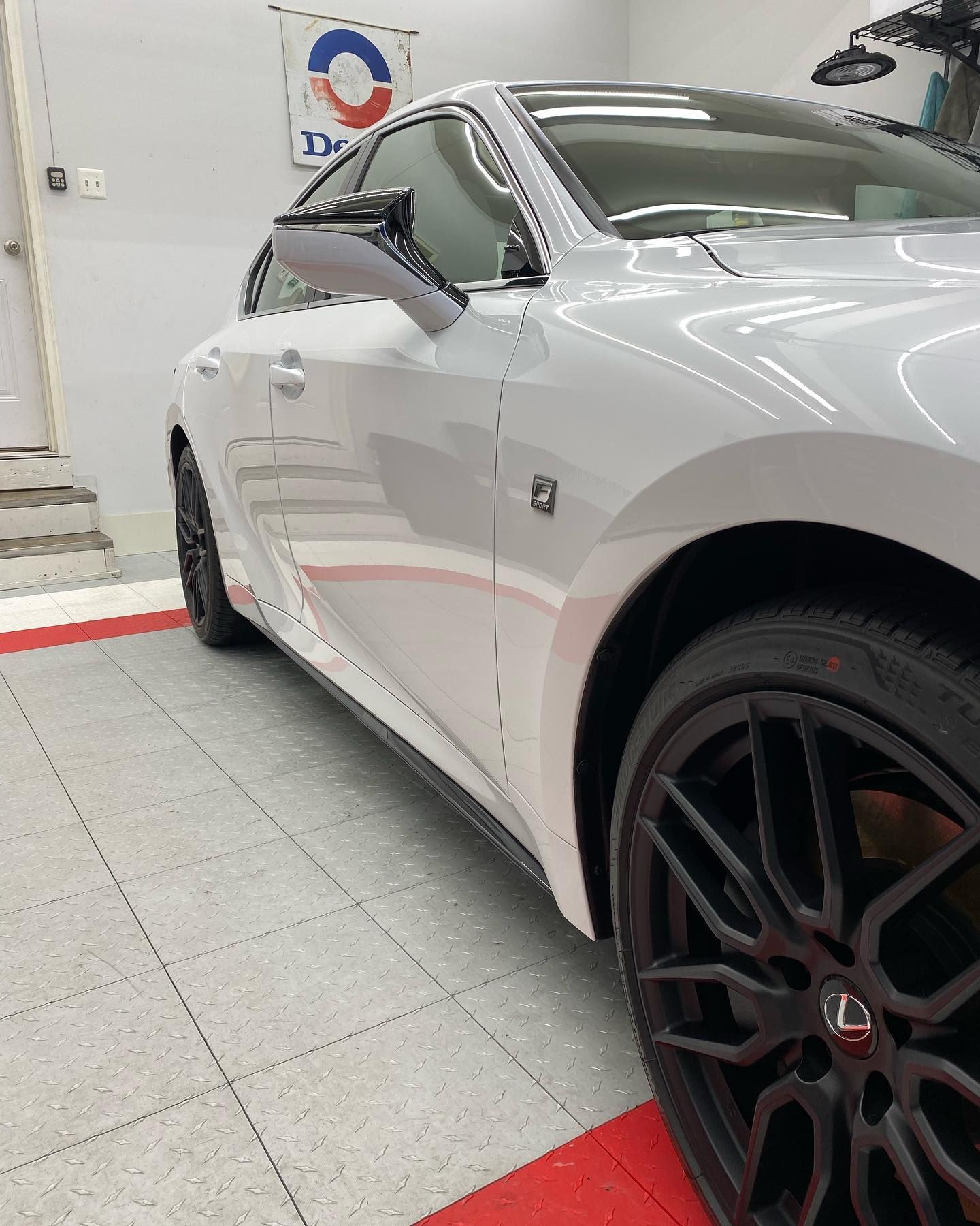 A white car with black wheels cleaned by thats clean