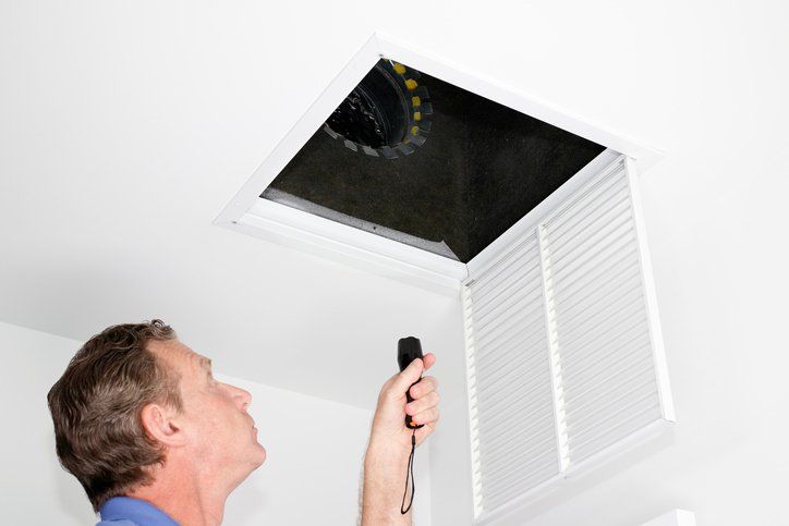 Man Inspecting Air Intake Duct — Broward County, FL — Indoor Air Quality Corporation
