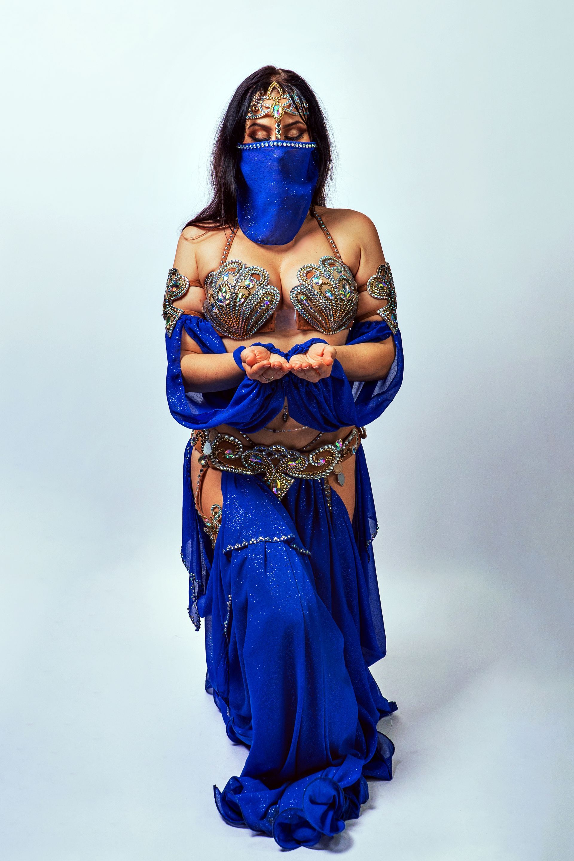 Belly dancer Azeeria Azizah in a blue and gold belly dancer costume