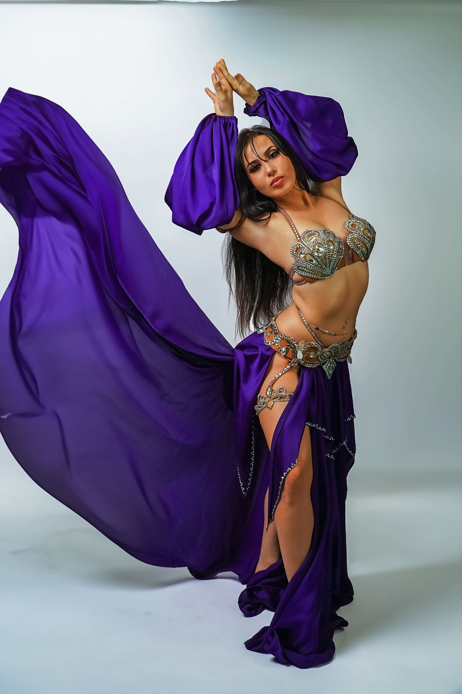 Belly dancer Azeeria Azizah in a purple dress is dancing