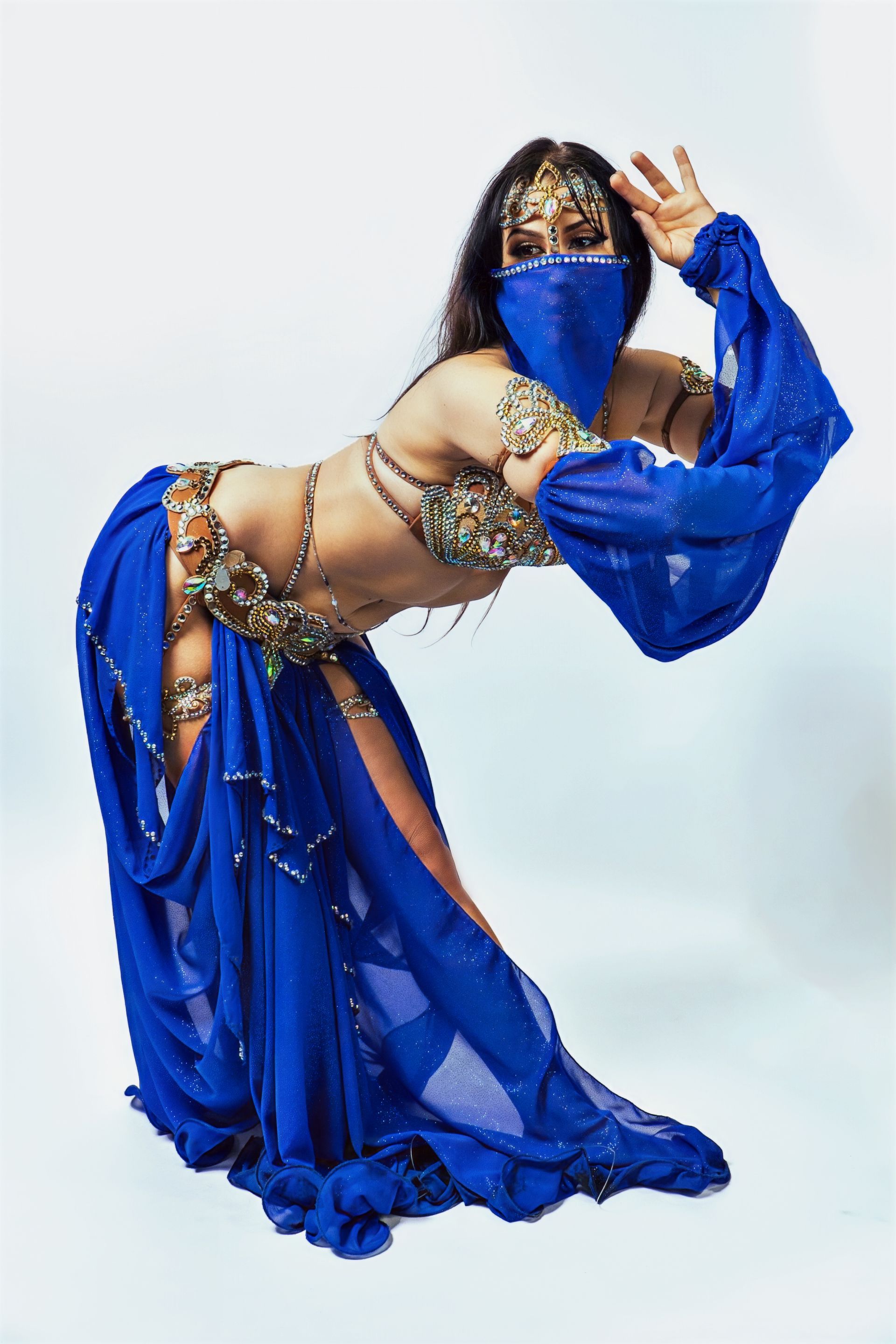 Belly dancer Azeeria Azizah is wearing a blue dress and veil.