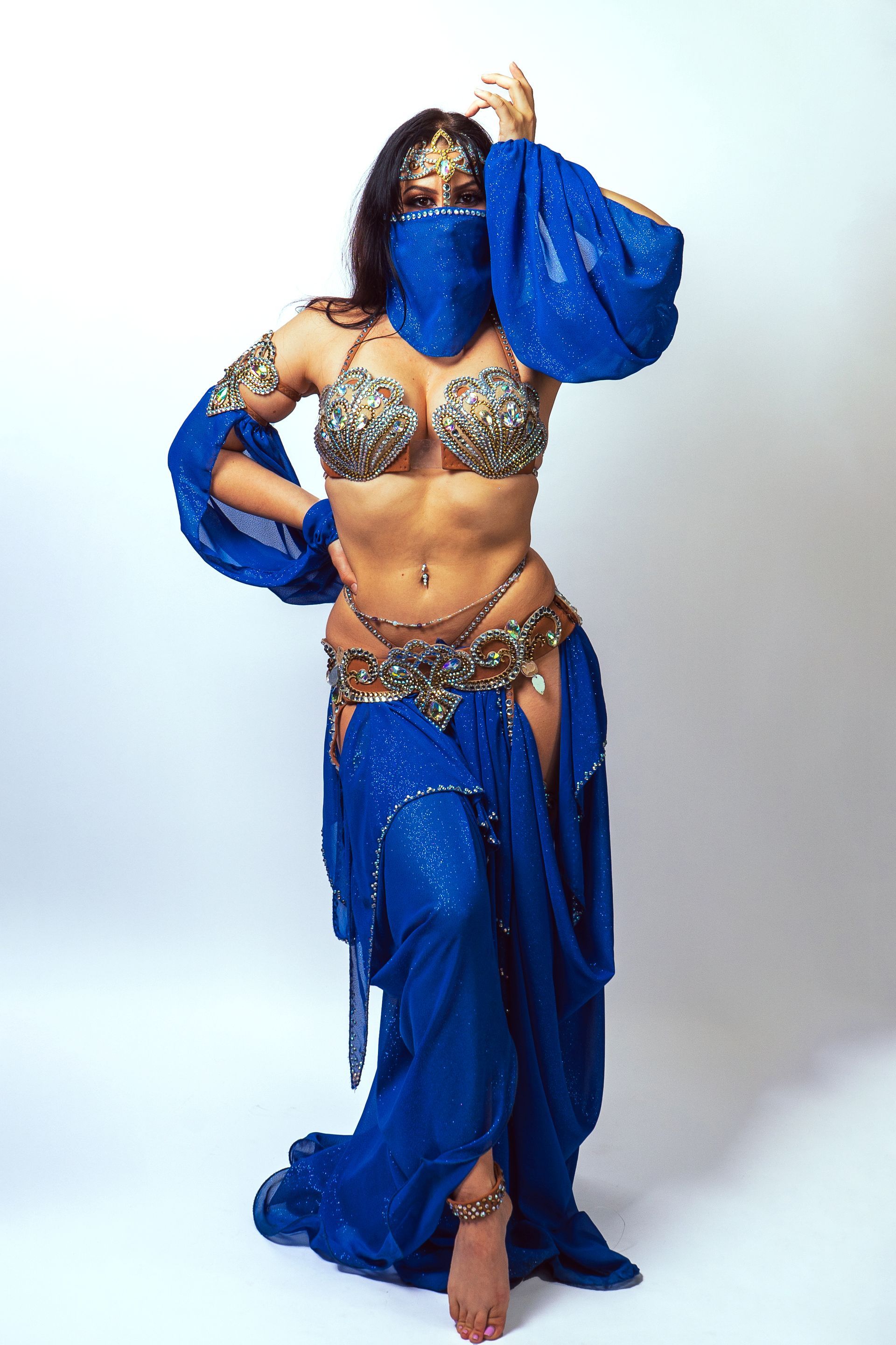Belly dancer Azeeria Azizah wearing a blue and gold costume