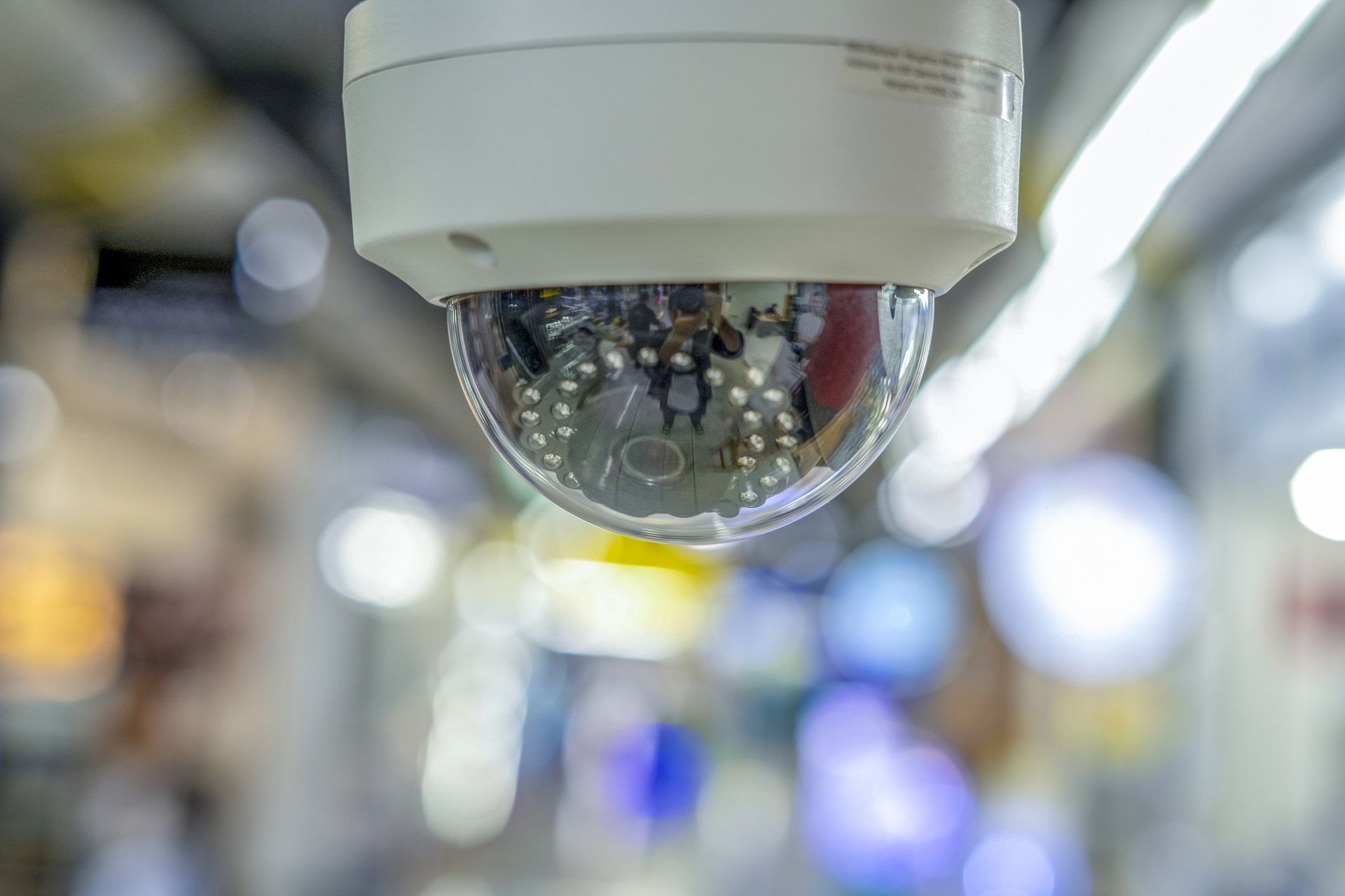 Close-up of dome security camera installed indoors as part of modern CCTV camera systems.