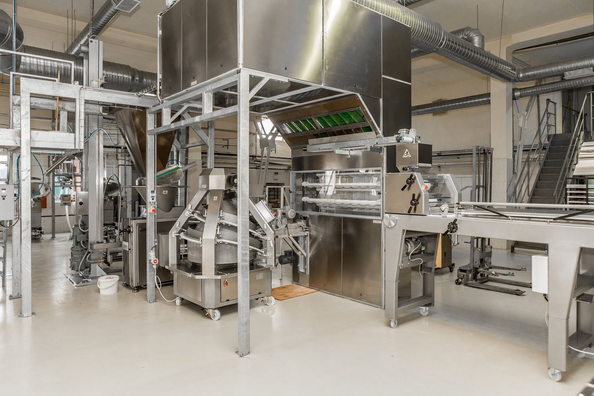 Industrial food processing machinery in a bright factory setting.