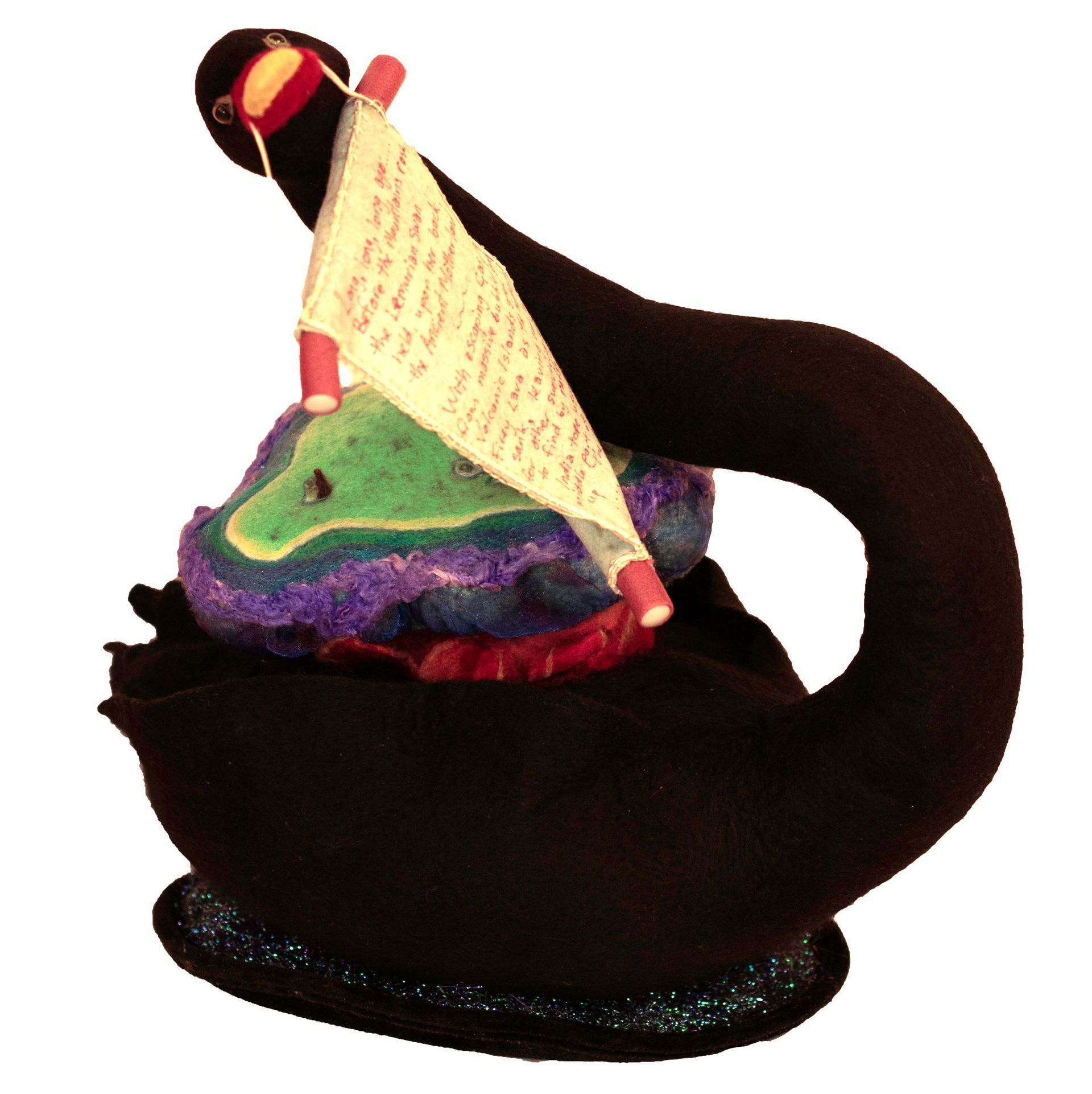 A black swan with a sailboat on top of it