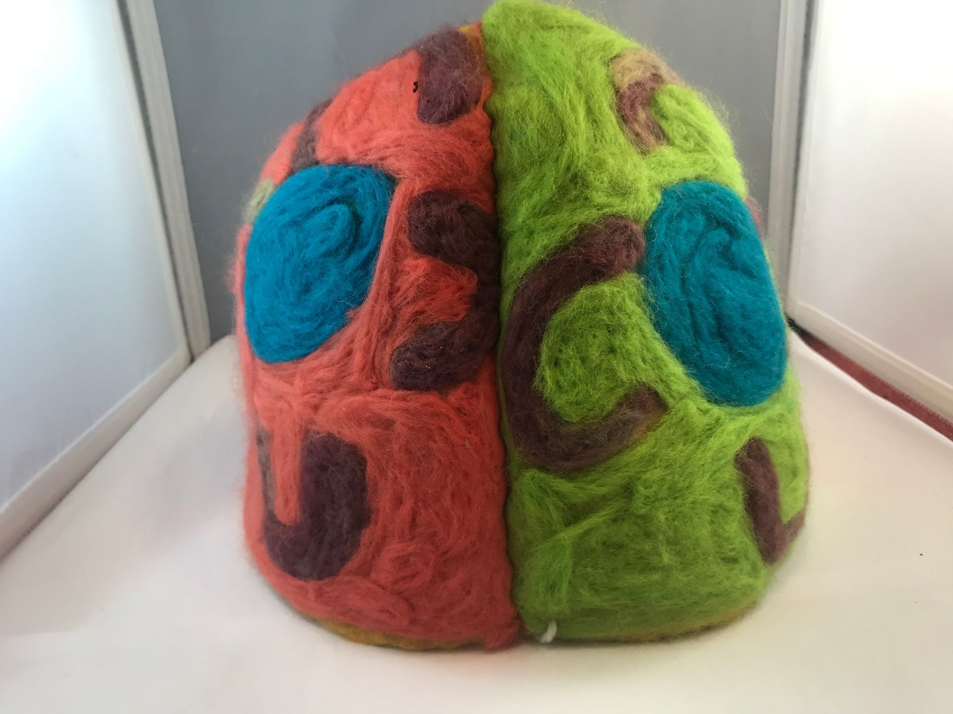 A red green and blue hat with a pattern on it