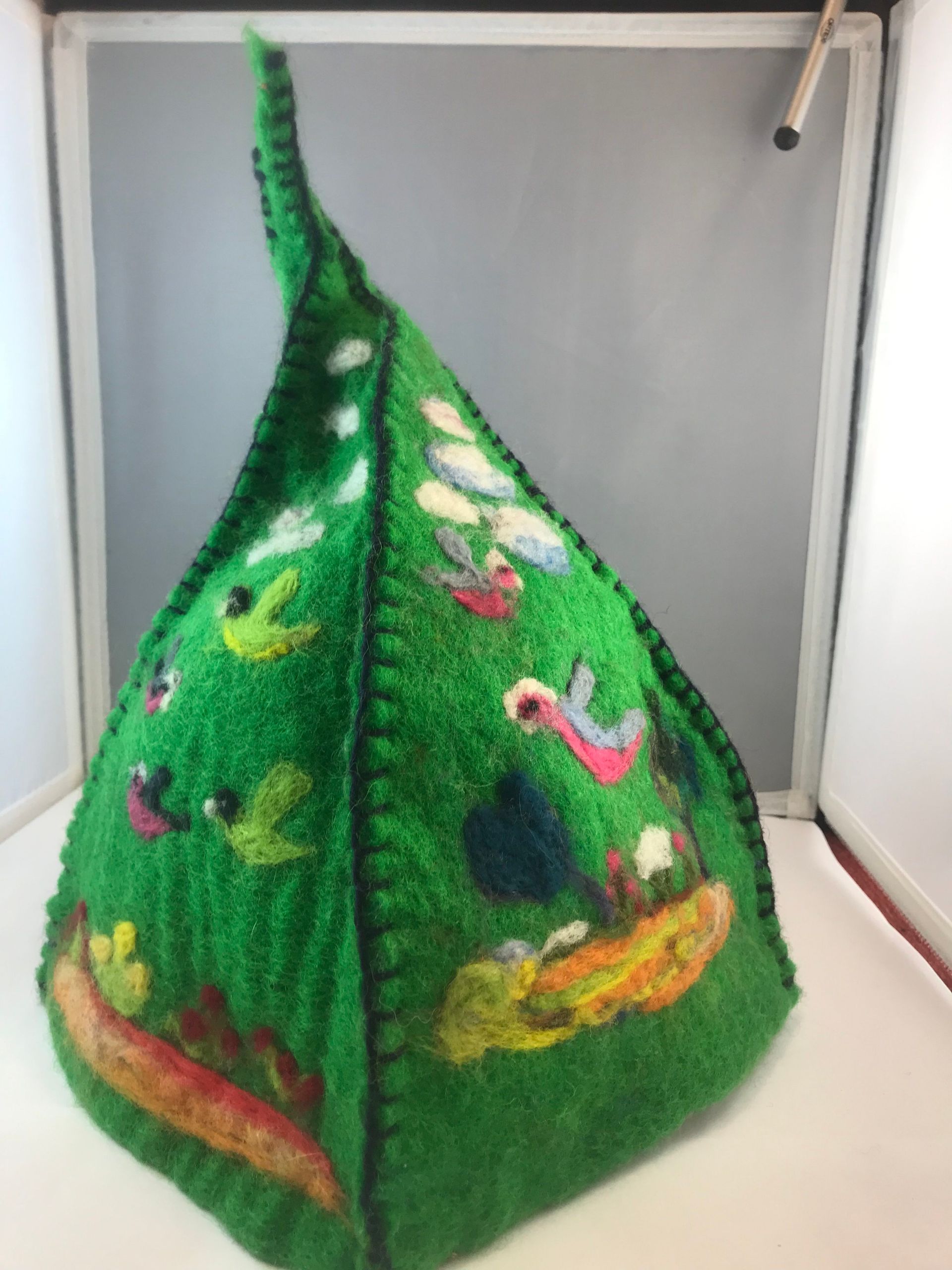 A green hat with a picture of a tree on it