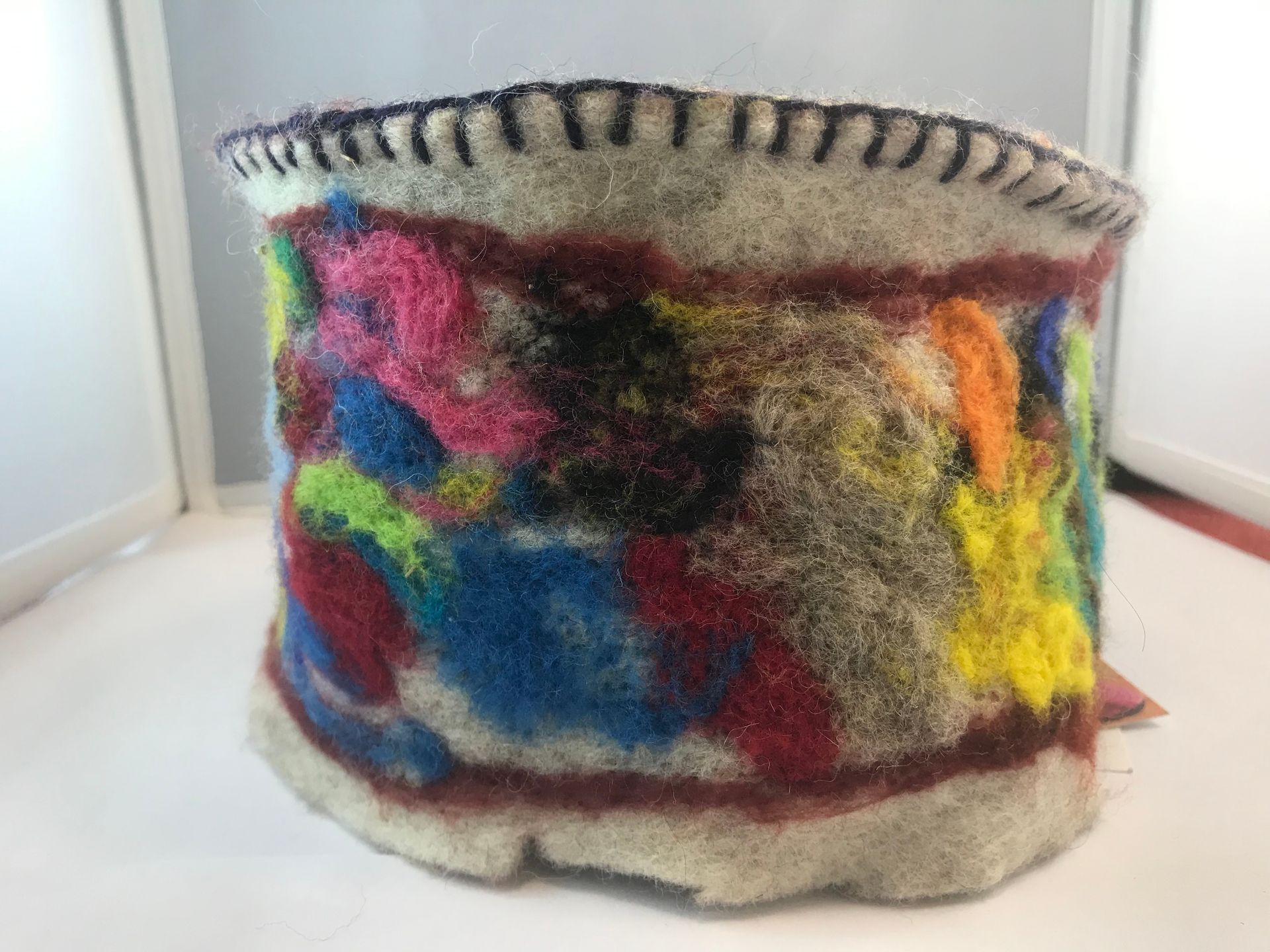 A colorful bracelet is sitting on a white table.