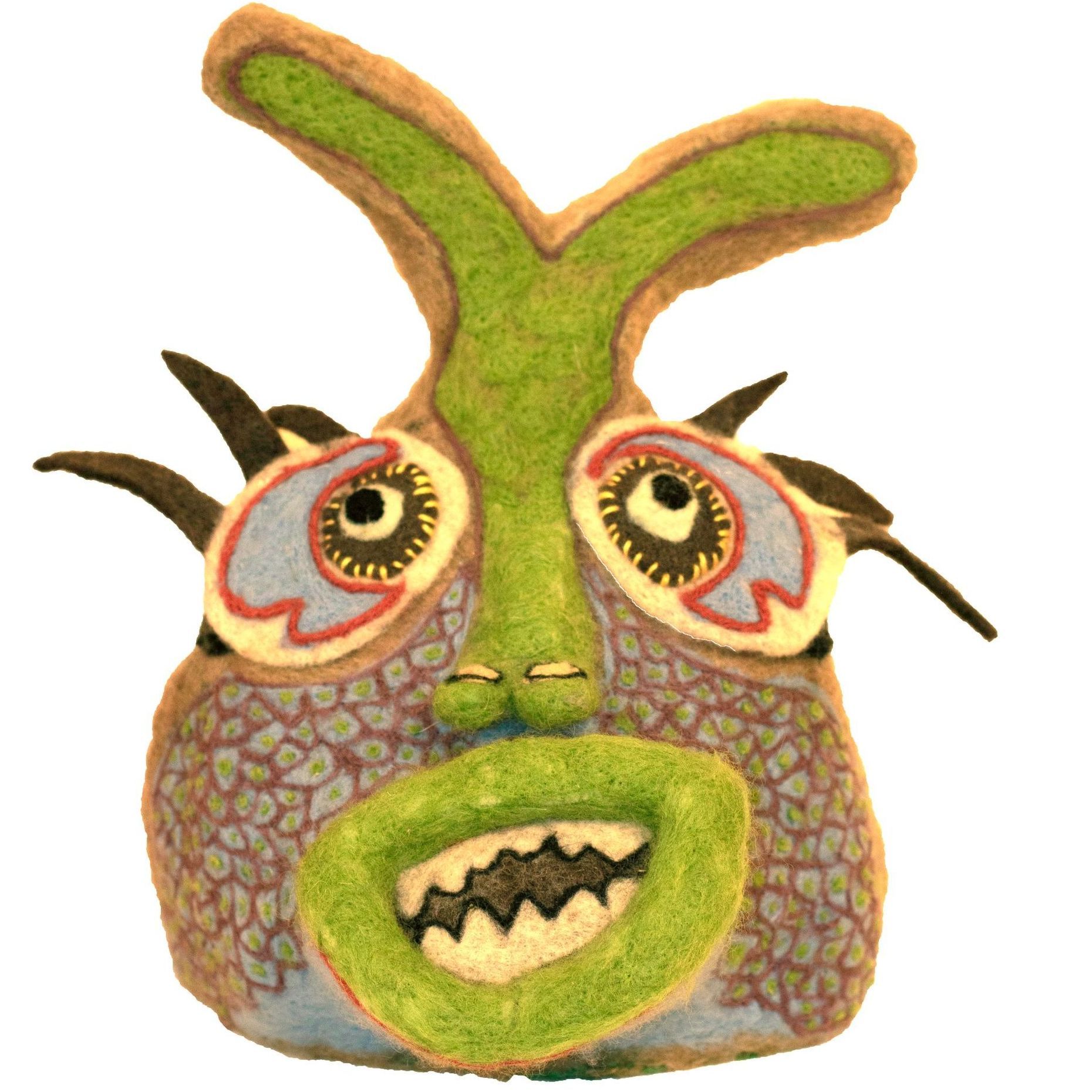 A stuffed animal with a green face and sharp teeth