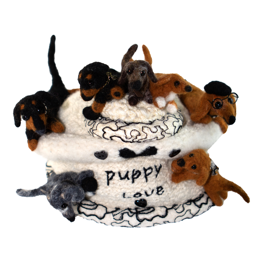 A puppy love cake with stuffed dogs on top
