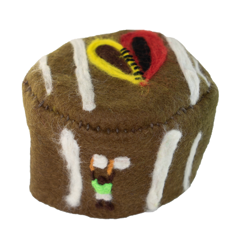 A brown and white cupcake with a heart on it