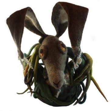 A stuffed animal with a rabbit 's head on a white background