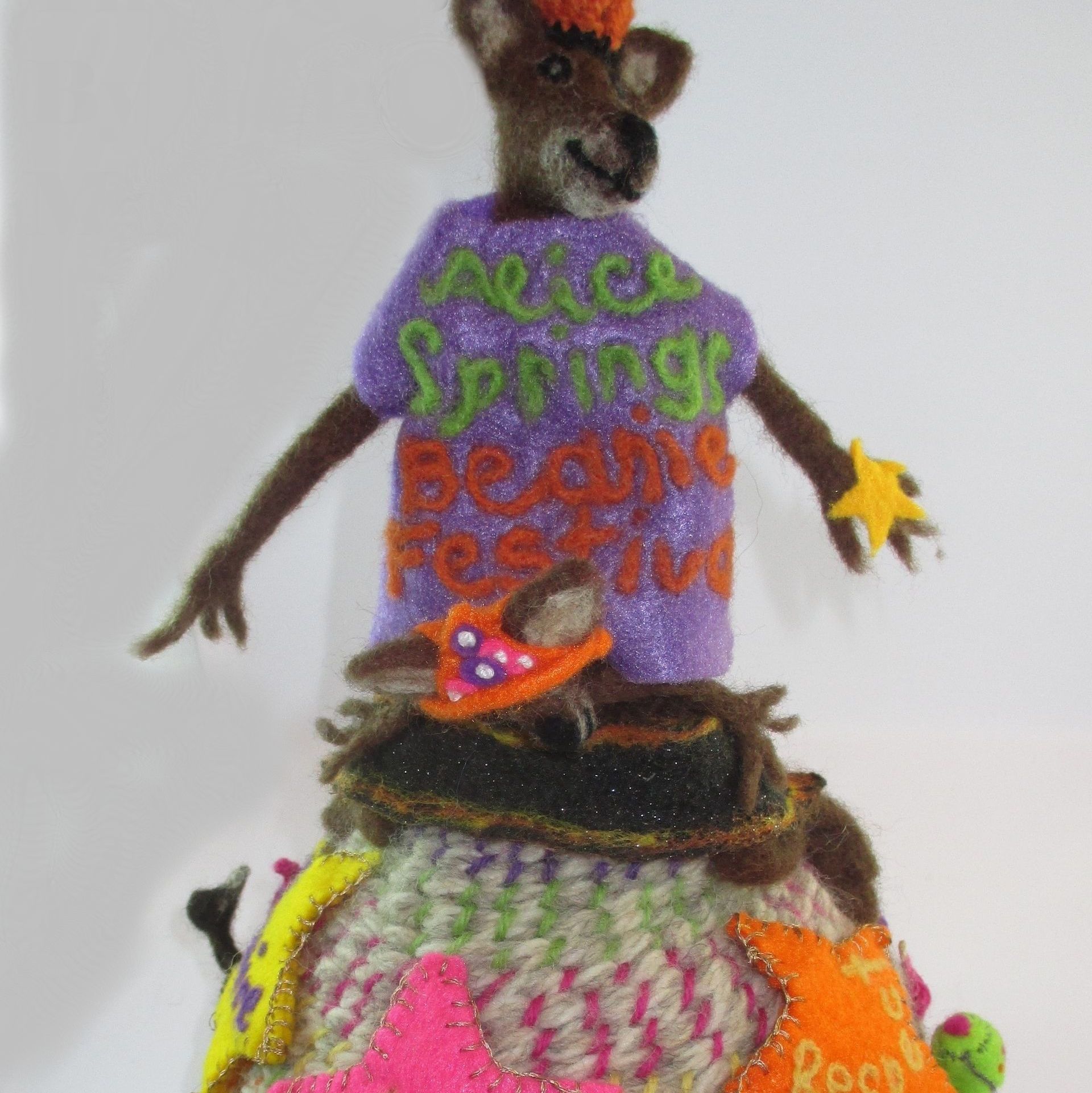 A stuffed animal with a purple shirt that says peace spring