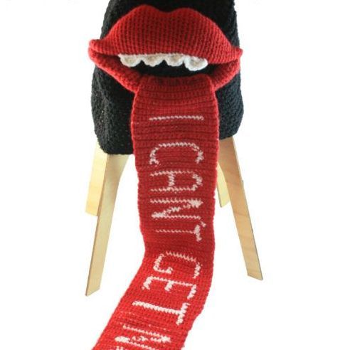 A red scarf with the word chanel on it