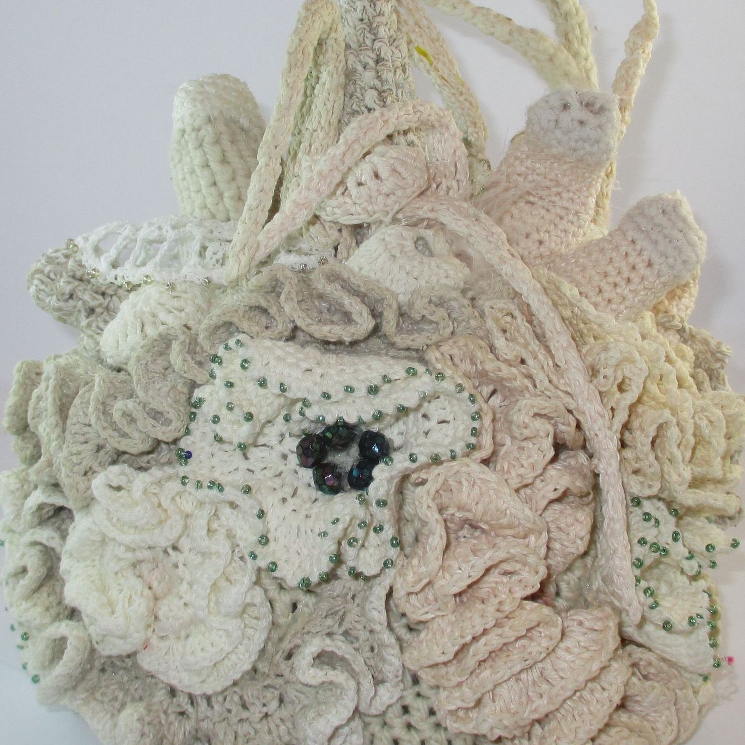 A close up of a crocheted purse with a flower on it