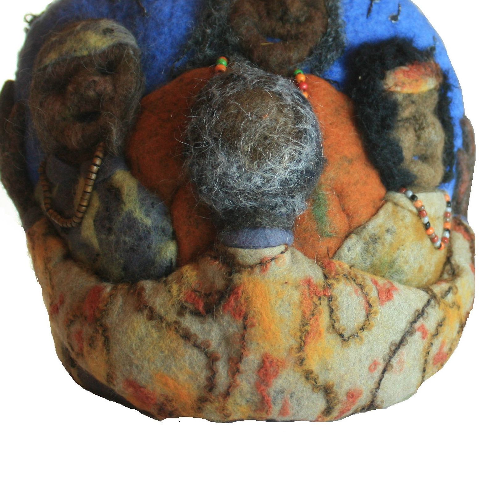 A group of people sitting in a circle with one wearing a blue shirt