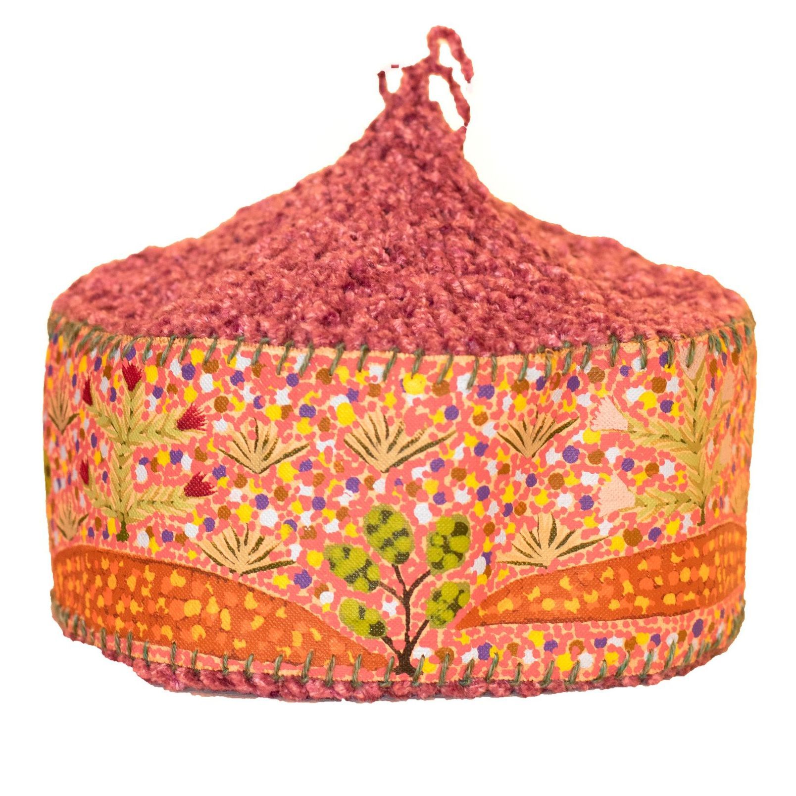 A pink and orange item with a tree on it