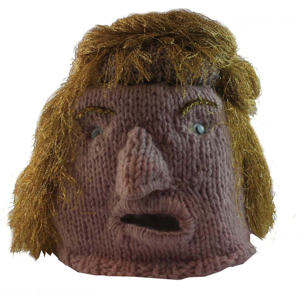 A knitted head with a surprised look on its face