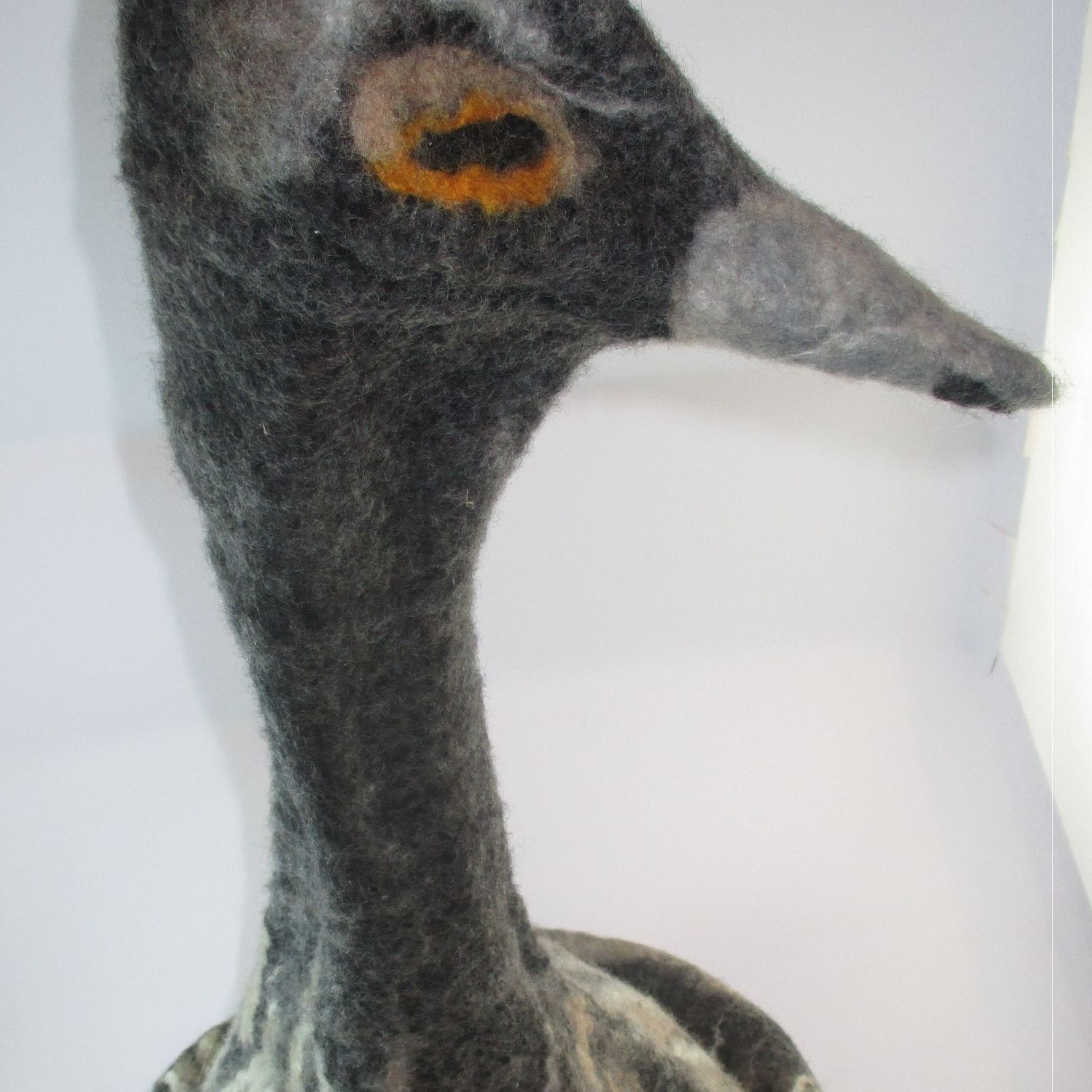 A close up of a stuffed duck with a long neck and a long beak.