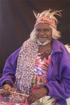 The woman is wearing a purple jacket and a leopard print dress.