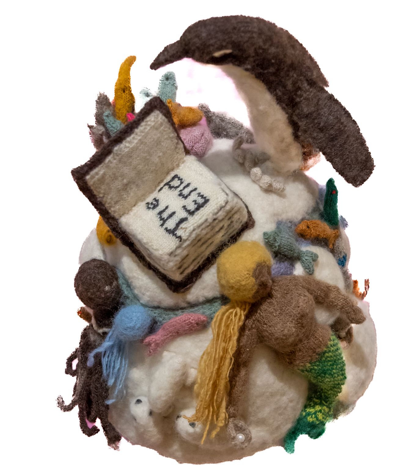 A stuffed animal with a book that says the bible on it