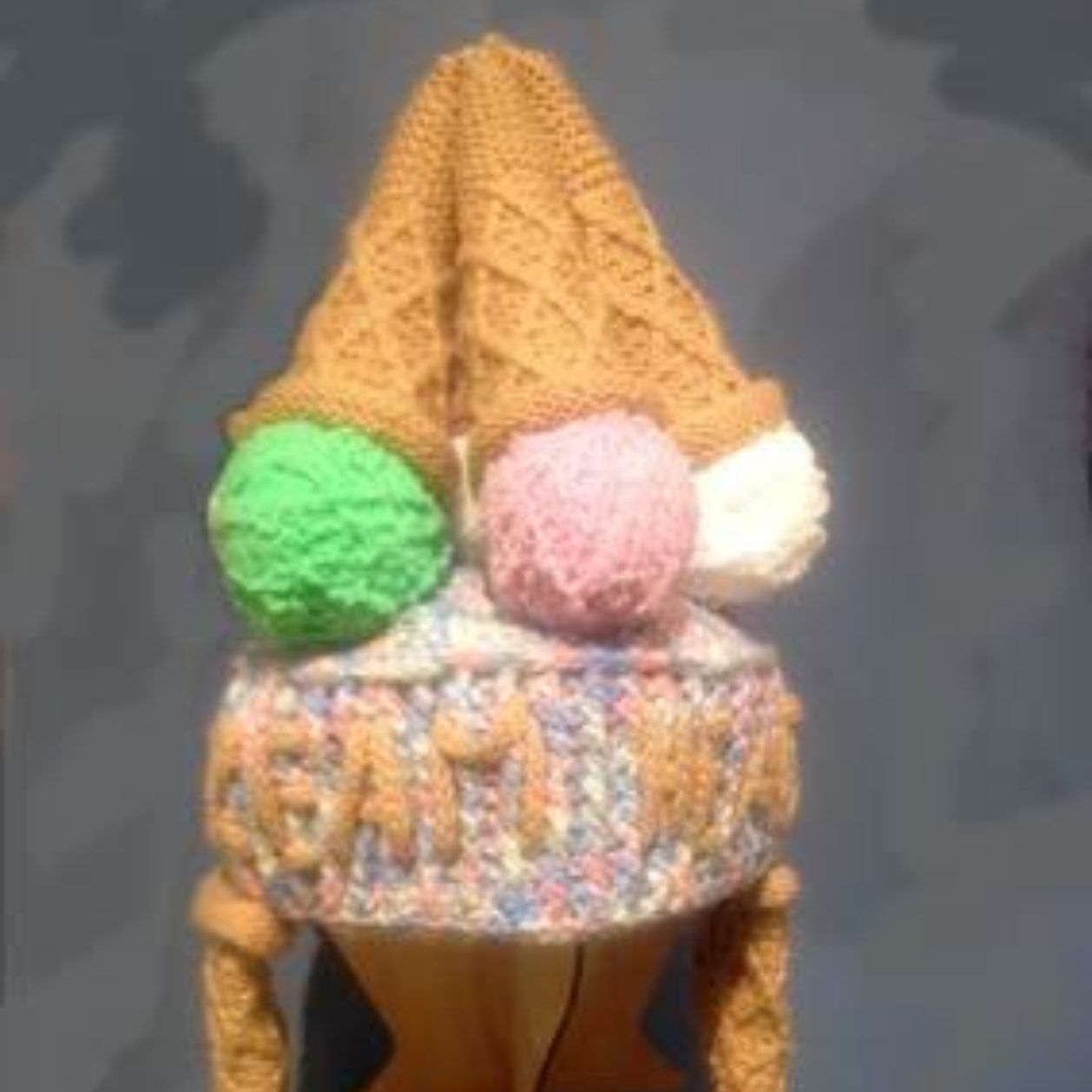 A hat that looks like an ice cream cone with balls of ice cream on top