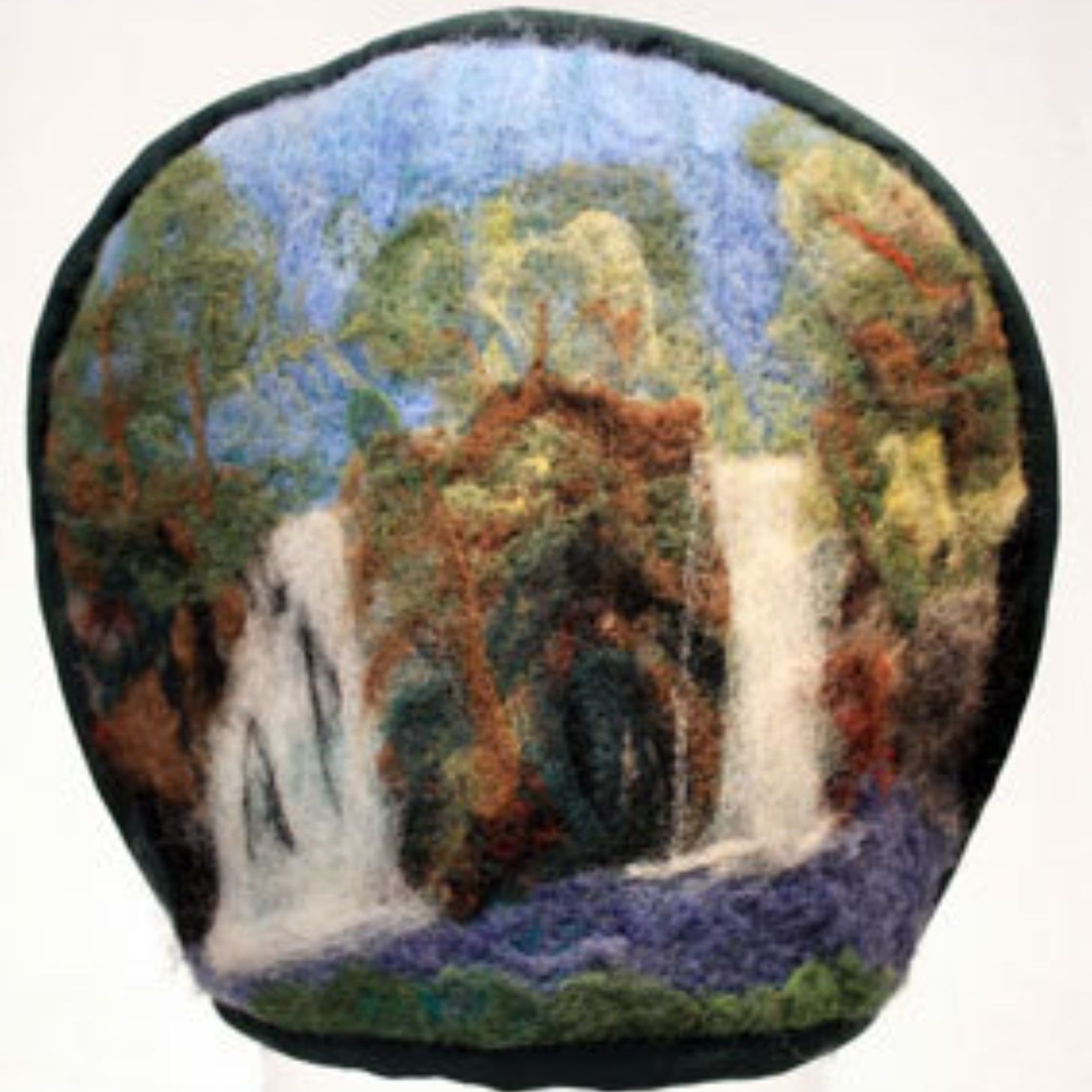 A pillow with a picture of a waterfall on it