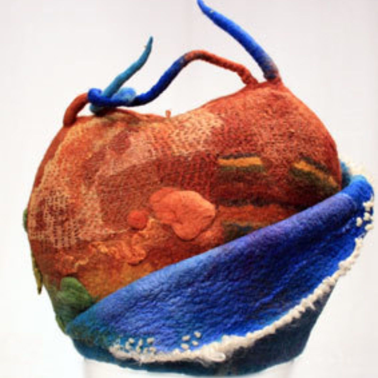 A sculpture of a globe with a blue ribbon around it