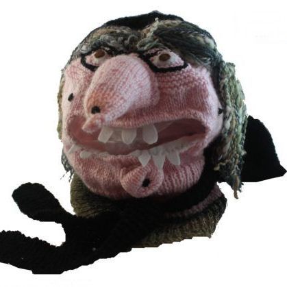 A knitted hat with a witch face on it