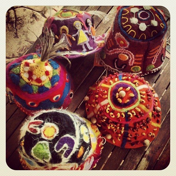 A bunch of colorful cakes are sitting on a wooden table