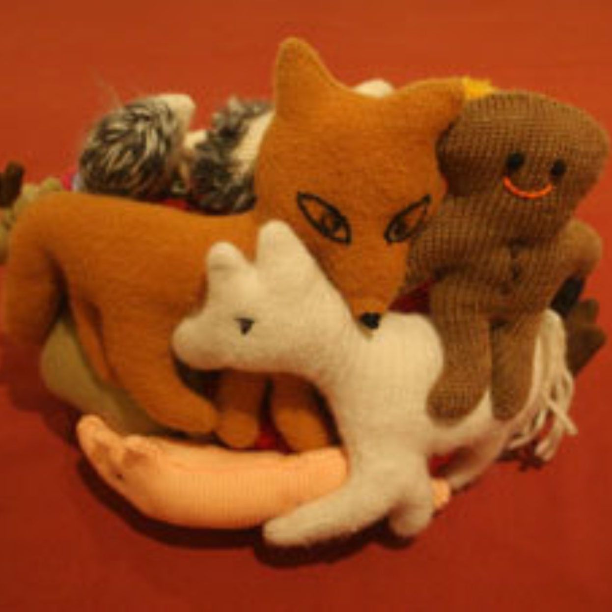 A pile of stuffed animals including a gingerbread man