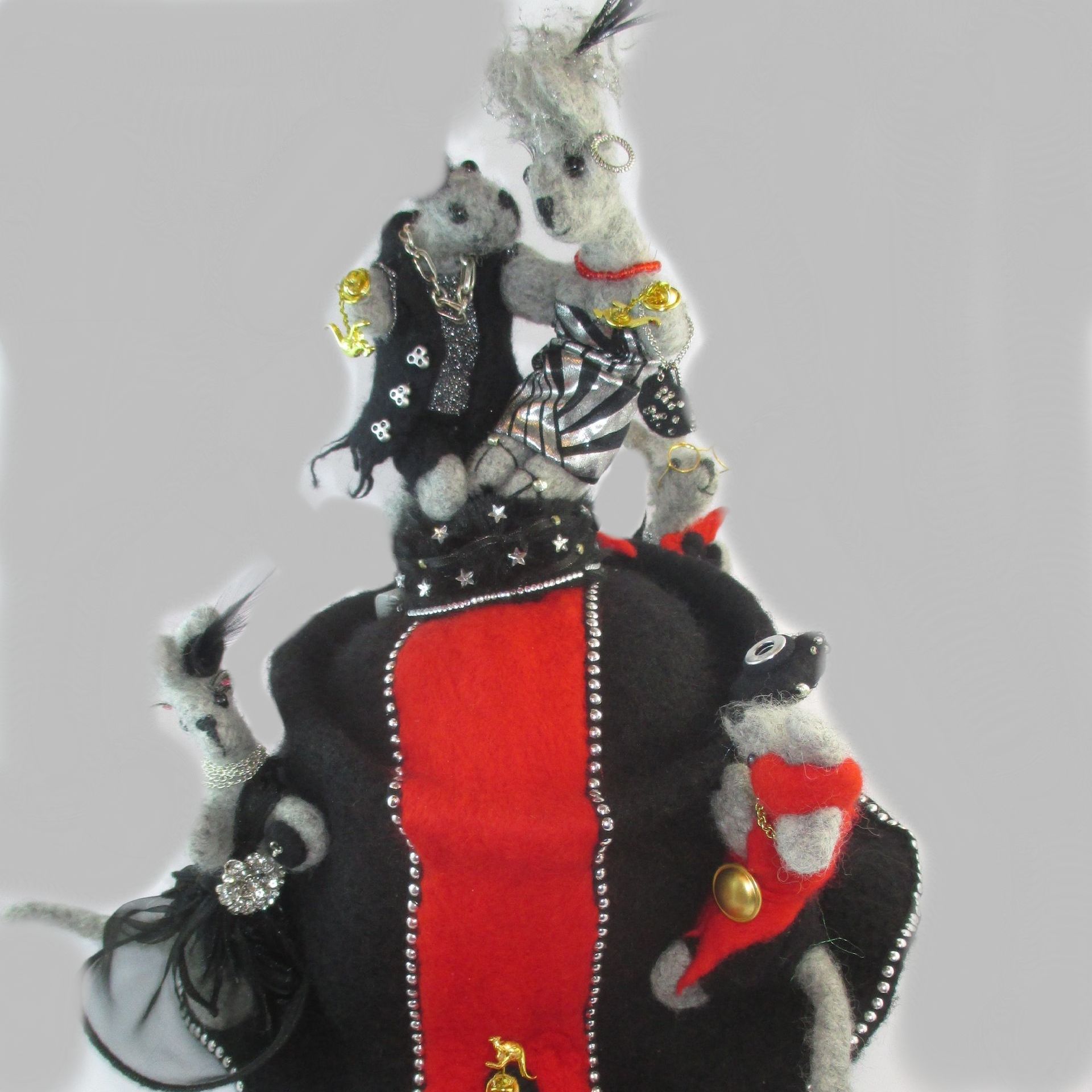 A stuffed animal with a red ribbon that says ' skeleton ' on it