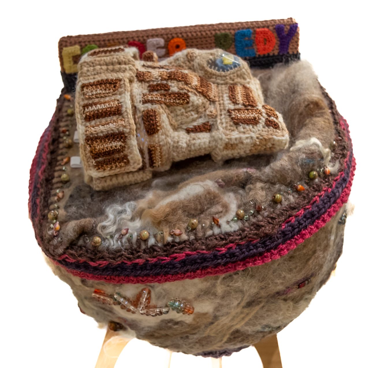 A crocheted item with the word lucky on it