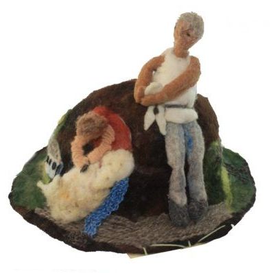 A figurine of a man standing next to a woman laying on a rock