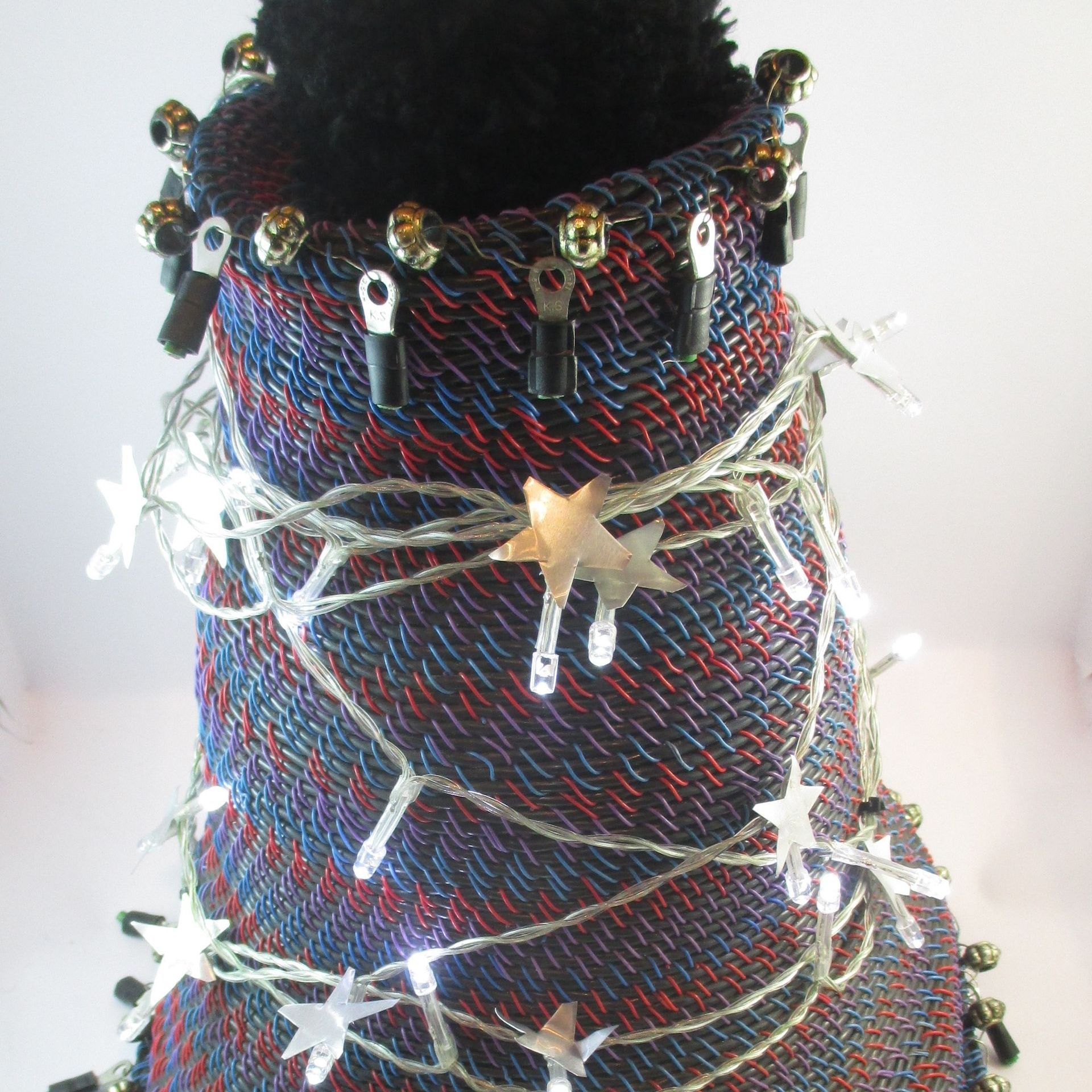 A christmas tree made out of a sweater with lights and stars