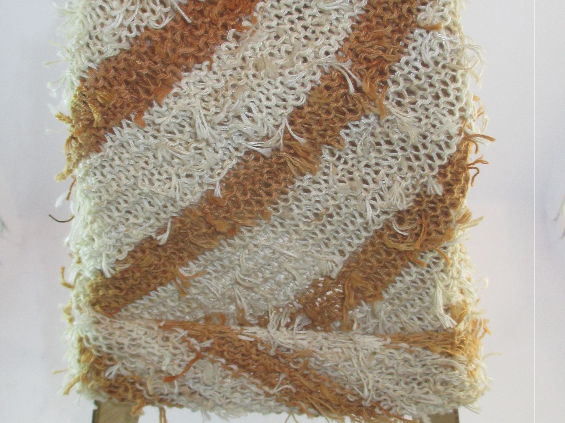 A close up of a piece of fabric with a brown and white striped pattern.