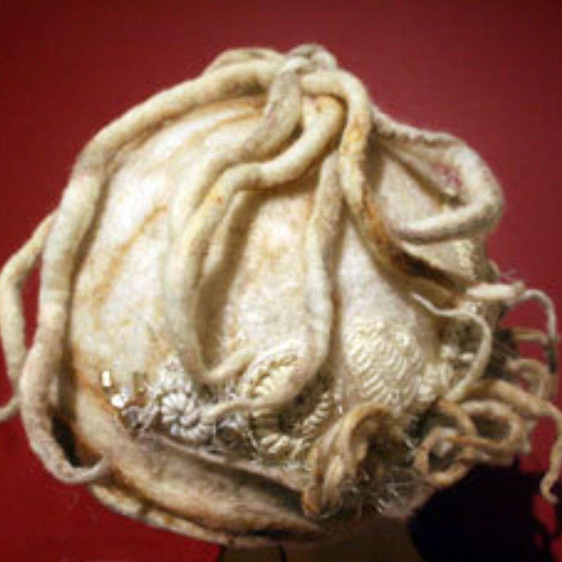 A close up of a person 's head with a hat on