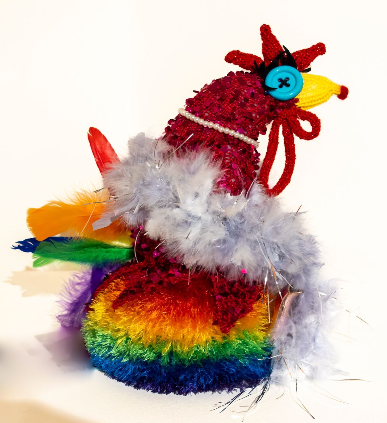 A colorful rooster with a blue button on its head