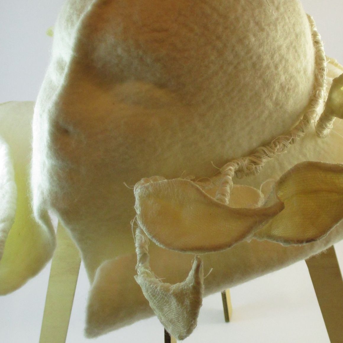 A close up of a hat on a mannequin head