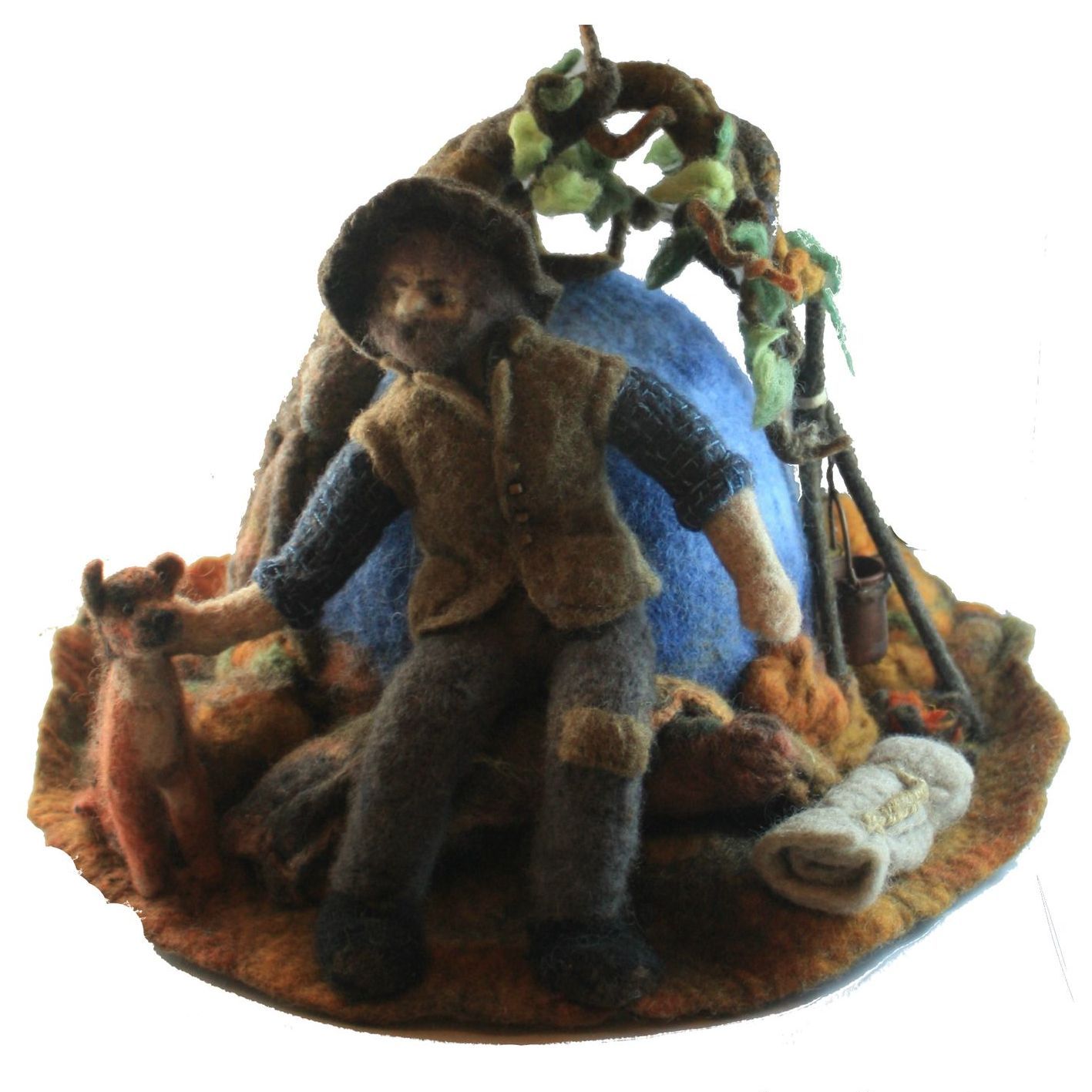 A figurine of a man sitting in front of a tent