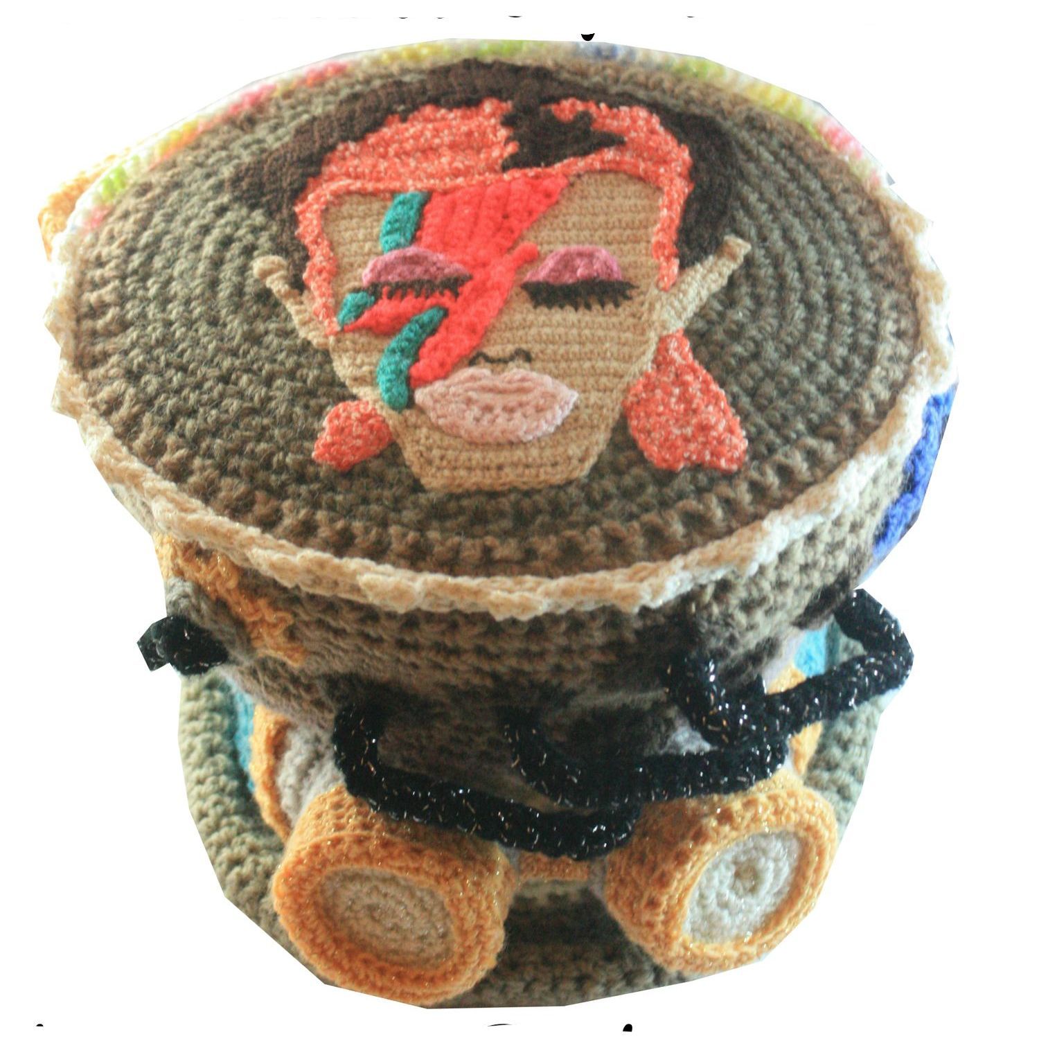 A crocheted hat with david bowie 's face on it