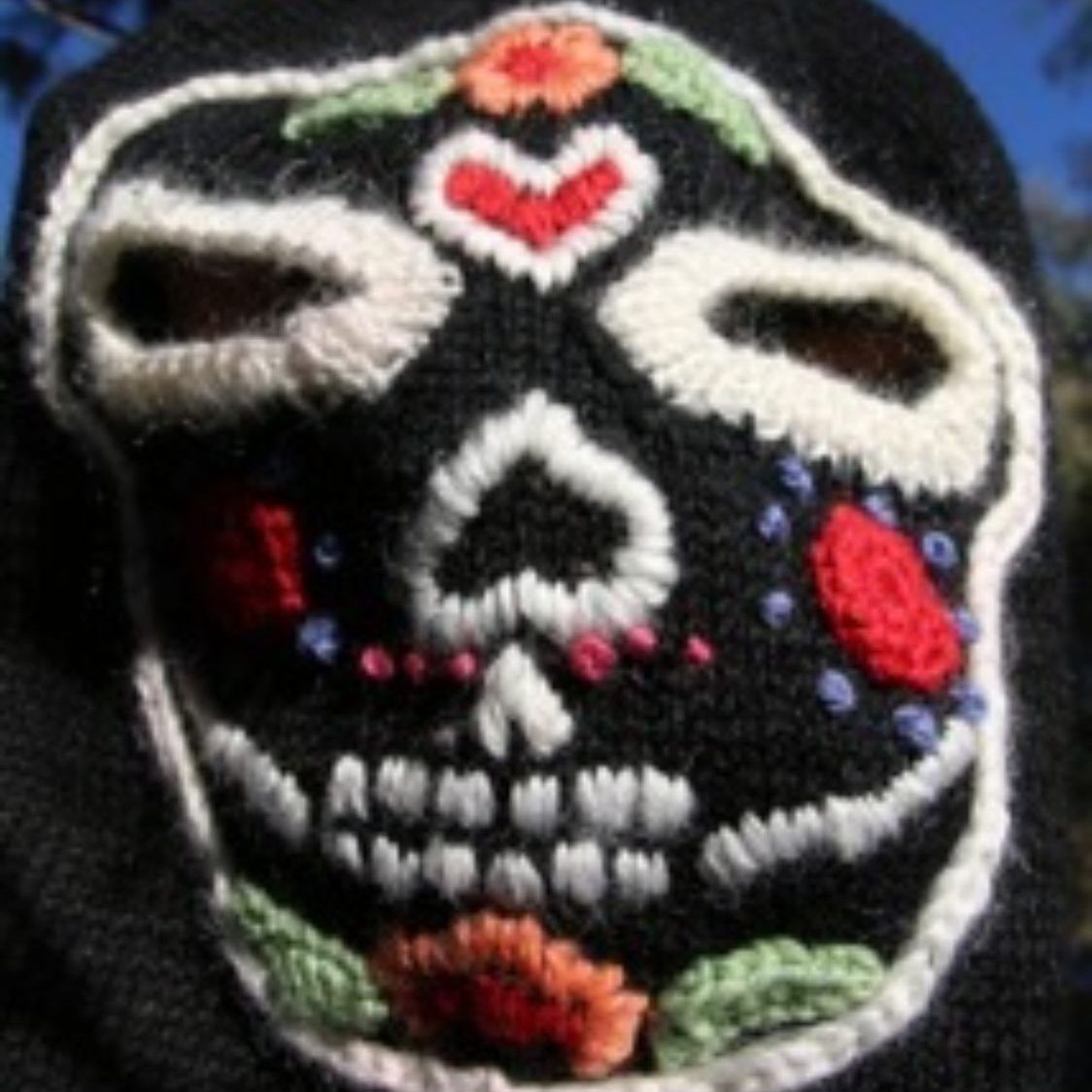 A black hat with a skull embroidered on it